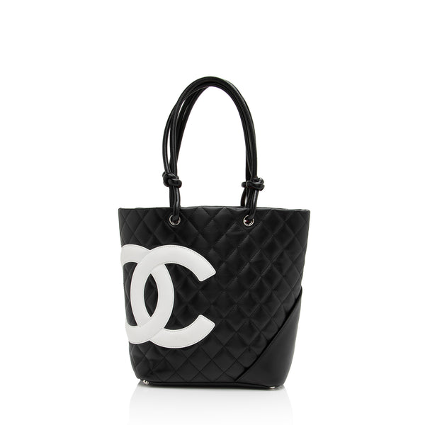 CHANEL, Cambon Ligne Flap Bag, beige quilted calf leather and cc logo in  black, silver details, front lock closes with cc logo branded lock, inner  woven logo patterned black lining, zipped compartment