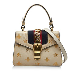 White gucci bag top with bee